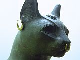 British Museum Top 20 11-2 Gayer-Anderson Cat Close Up 11. Gayer-Anderson Cat � Saqqara Egypt, after 600BC, 42cm high. Here is a close up showing the gold rings, a silvered collar round its neck and a silver protective wedjat eye amulet.